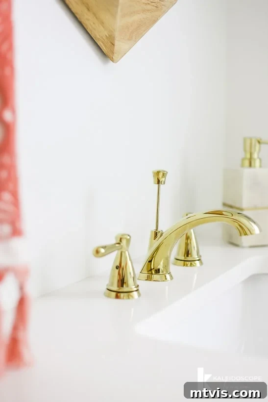 Handmade Hues: Our Vibrant Bathroom Makeover 13 Delta Peerless Faucet in polished brass, reflecting the colorful wall mural.