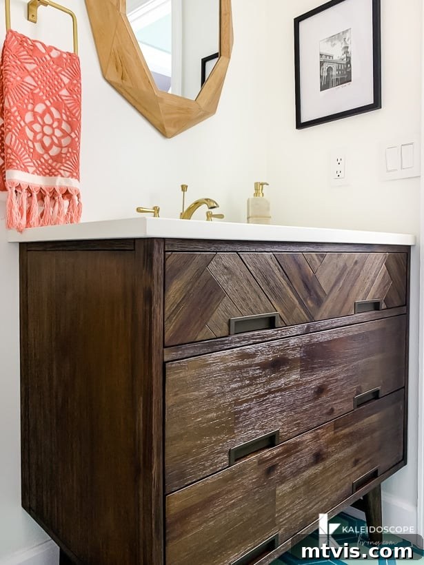 Handmade Hues: Our Vibrant Bathroom Makeover 9 Signature Hardware Danenburg vanity with herringbone pattern and mid-century modern legs in a powder room.