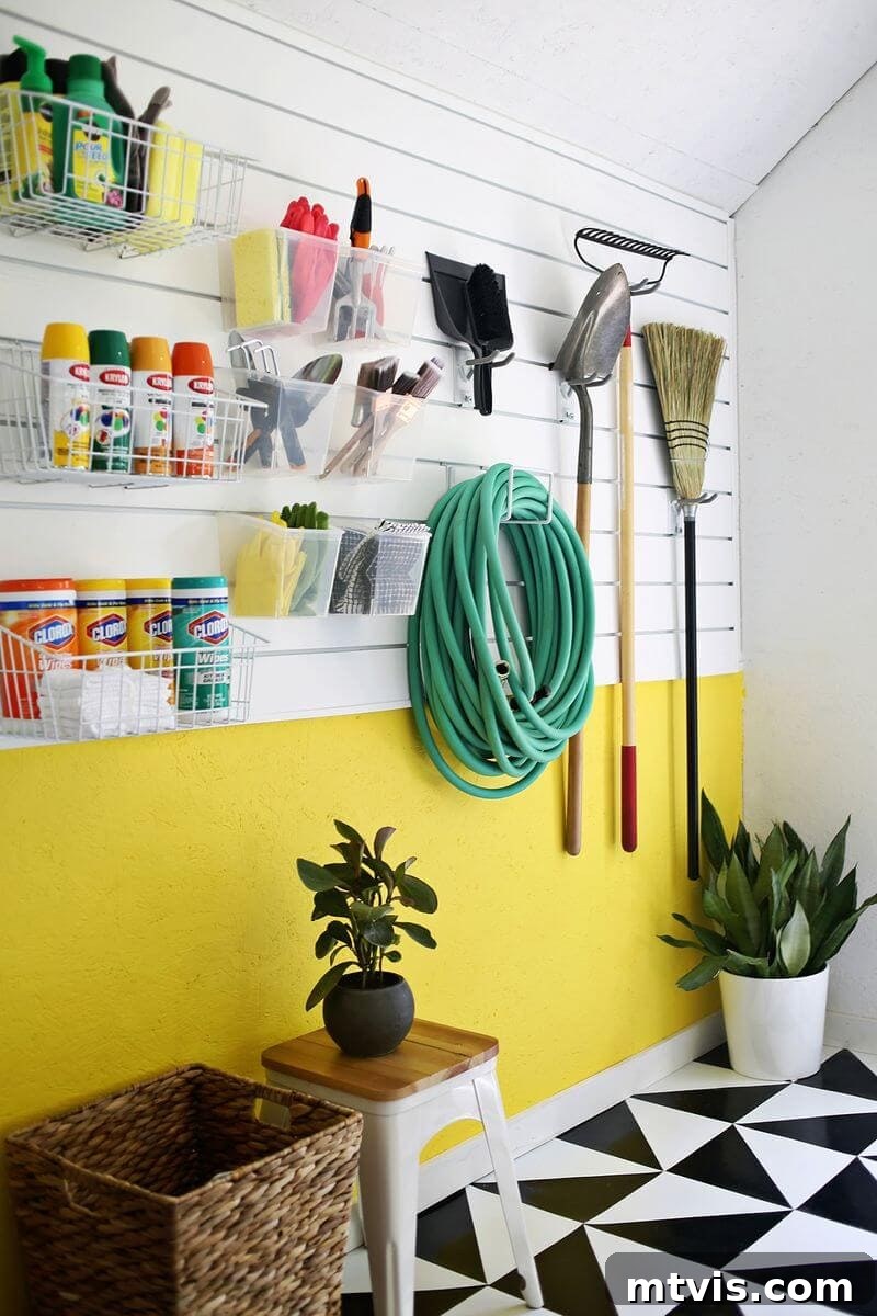 Colorful garage featuring a slat wall organization system, wall baskets, and hooks for tools.