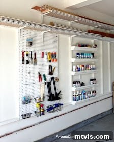 Simple pegboard and gutter shelves garage organization, perfect for spray paint and small tools.