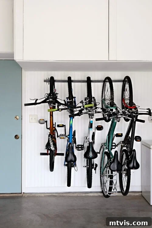 Efficient hanging bike storage solution in a garage, maximizing floor space.