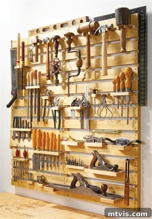 DIY tool rack built with a simple wood pallet design, ideal for organizing numerous hand tools.