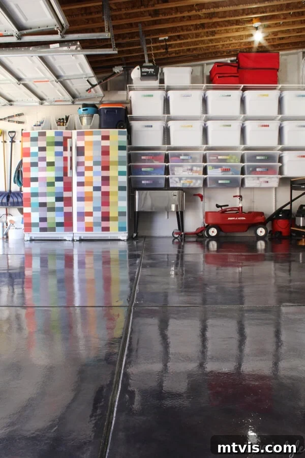 Organized garage featuring affordable wire shelves, a fridge decorated with paint chips, and a stylish painted floor.
