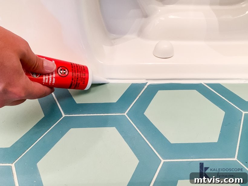 applying caulk around the base of the toilet