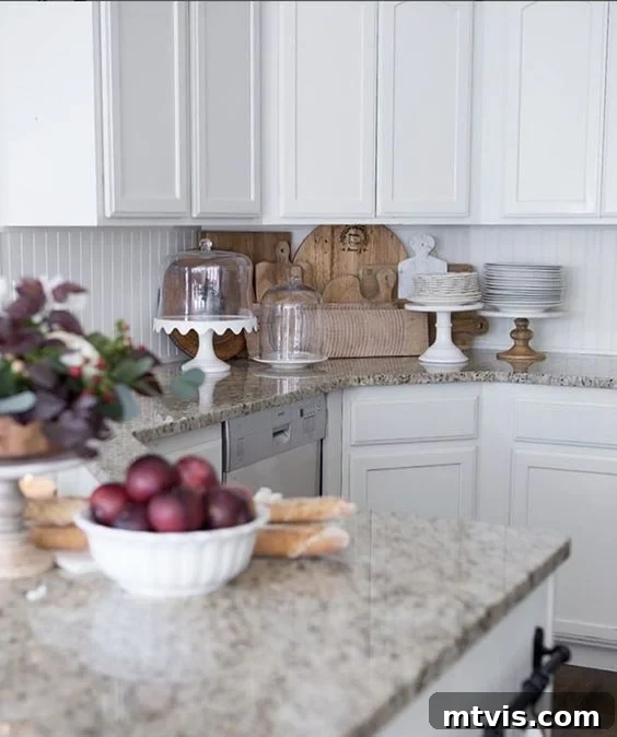 Budget DIY Kitchen Backsplash Makeovers 12 A DIY white beadboard backsplash contributes to a spacious and bright atmosphere in a white kitchen.