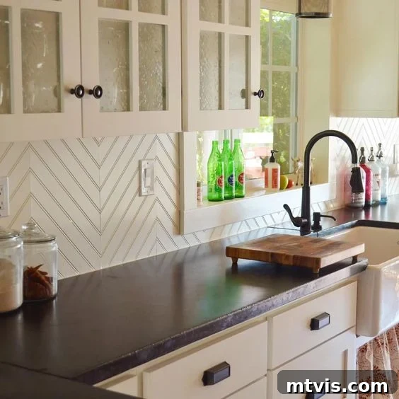 Budget DIY Kitchen Backsplash Makeovers 14 White chevron beadboard provides a fresh and modern budget-friendly backsplash in this black and white kitchen.