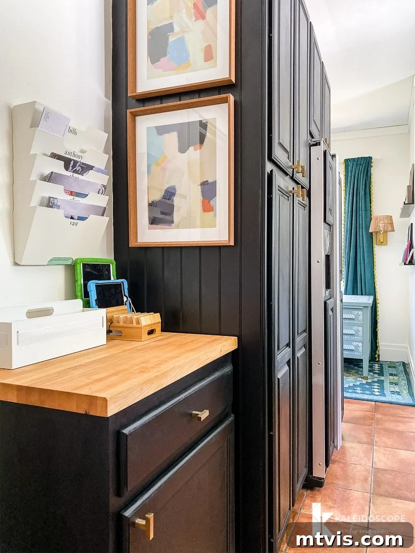 DIY Kitchen Transformation Under One Thousand 18 A family "command center" on a small cabinet with a wood top on the other side of a large pantry wardrobe, all added in a budget-friendly kitchen makeover.