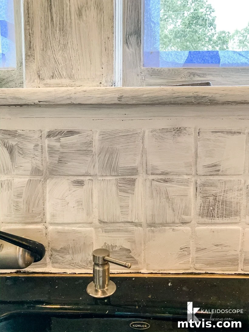 backsplash after applying primer, showing patchy coverage