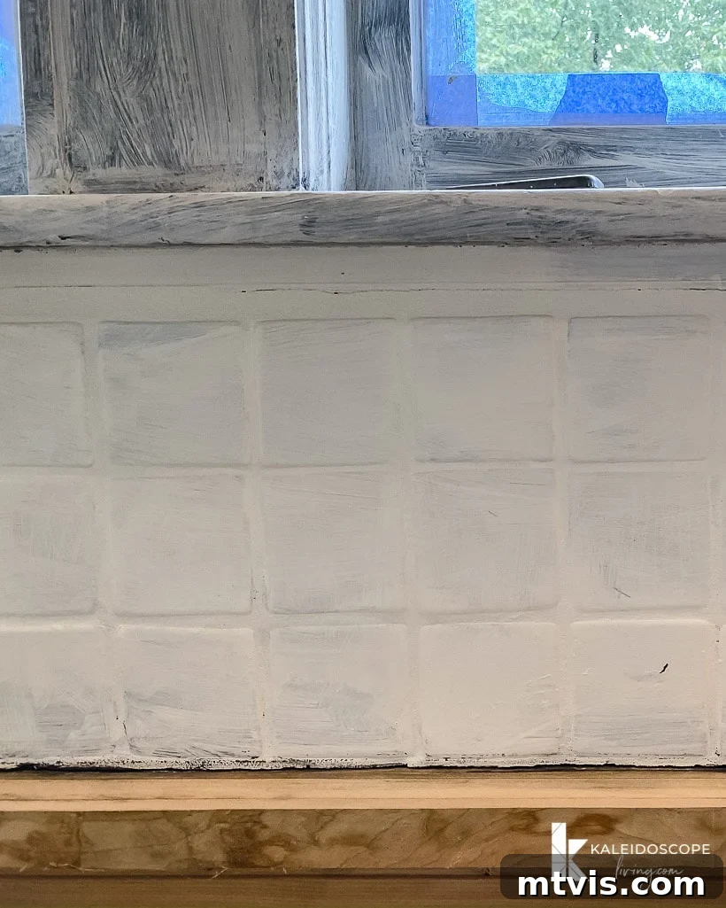 backsplash after applying one coat of white paint