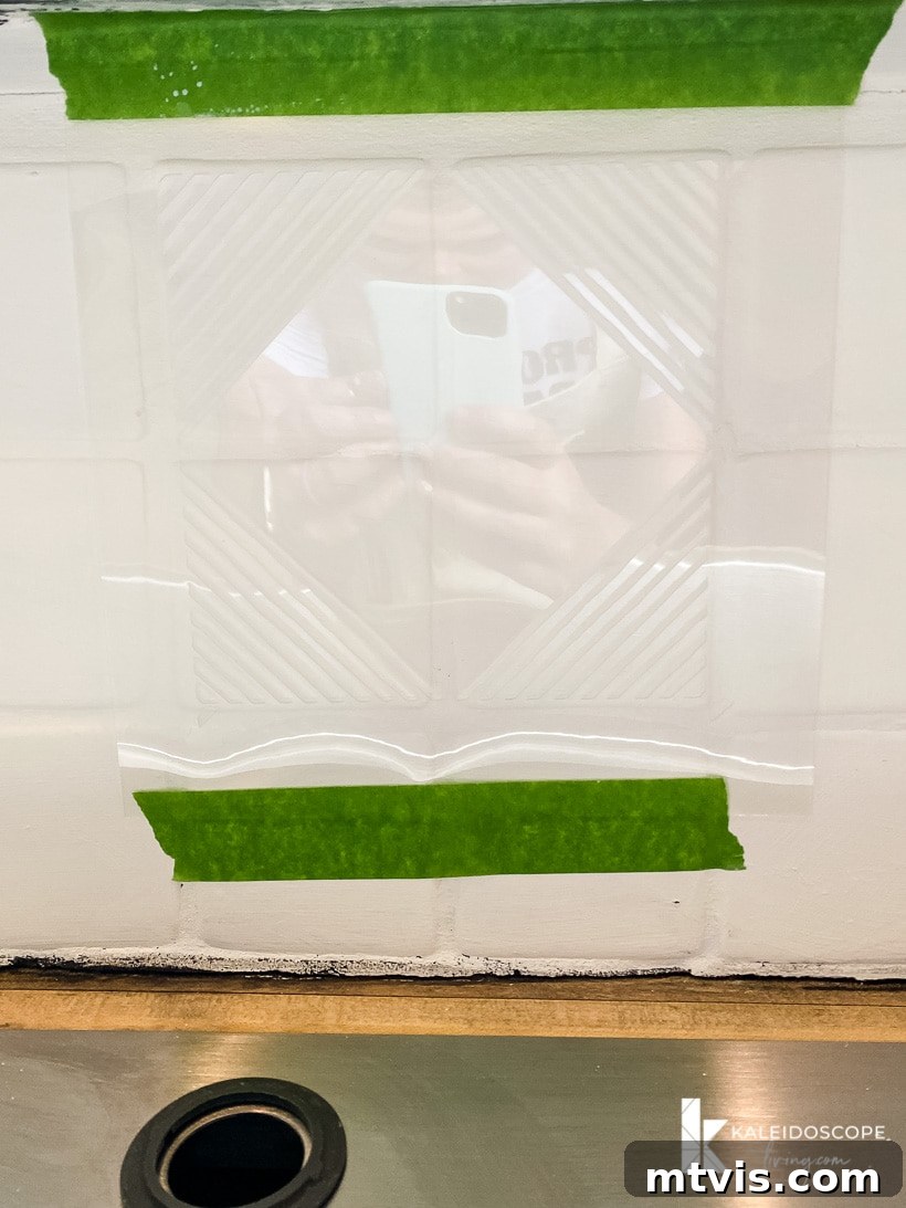 Backsplash Makeover Paint Your Tiles Like a Pro in 5 Steps 9 applying a geometric stencil to a painted kitchen backsplash