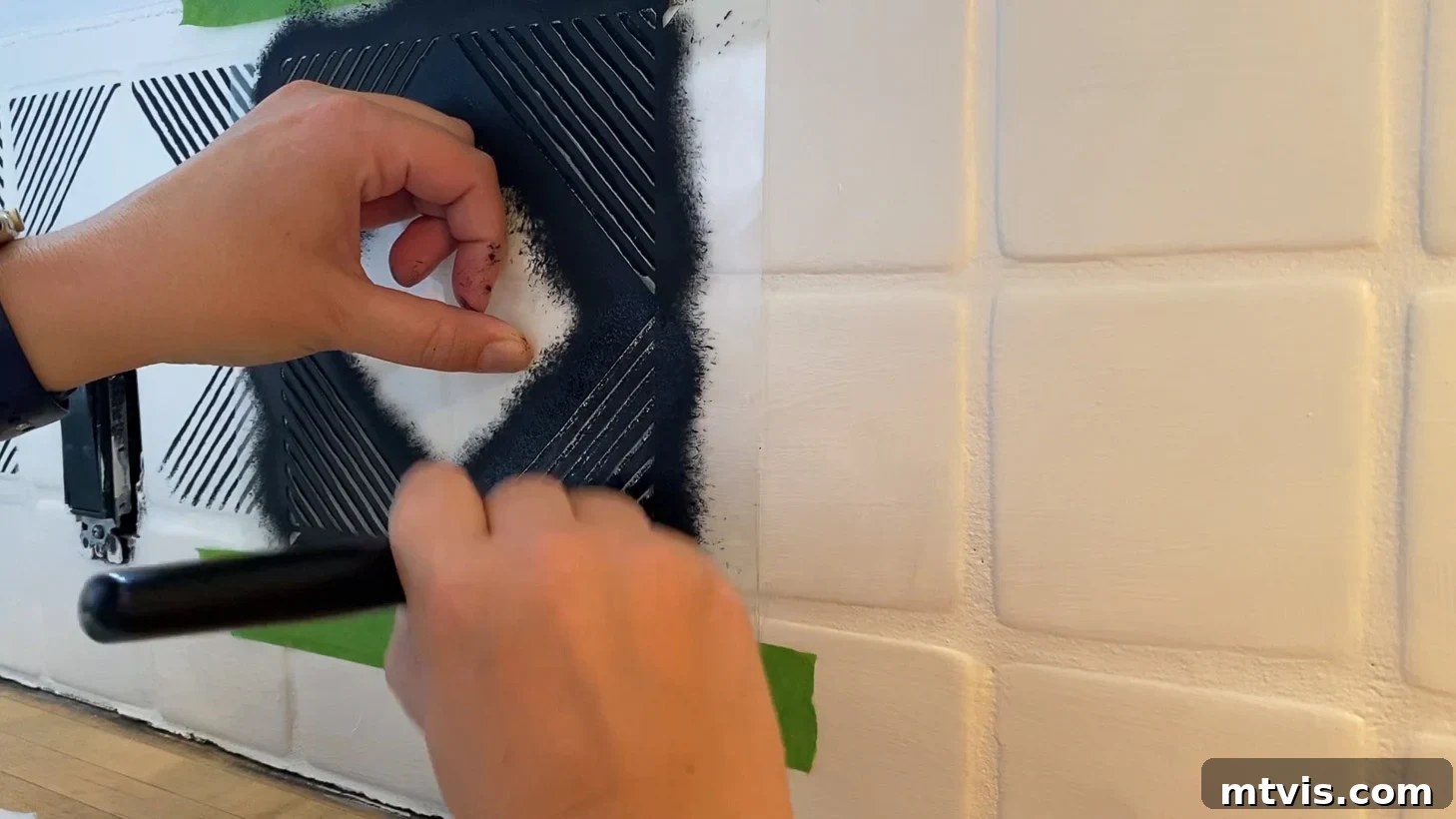 close-up of stenciled painted tile backsplash