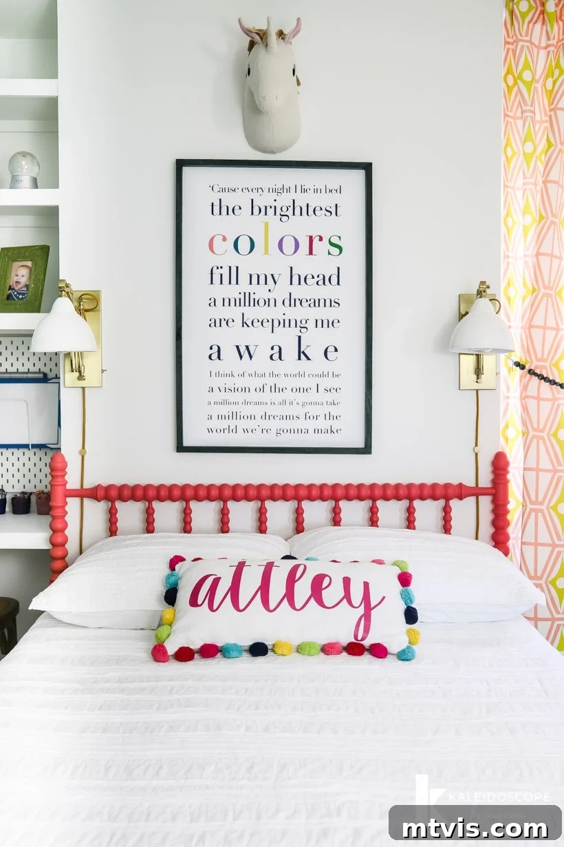 Close-up of Attley's colorful girl's bedroom, featuring the beautifully painted coral Jenny Lind bed, personalized song lyric art above, and whimsical decor elements, showcasing creative girl's room design ideas.