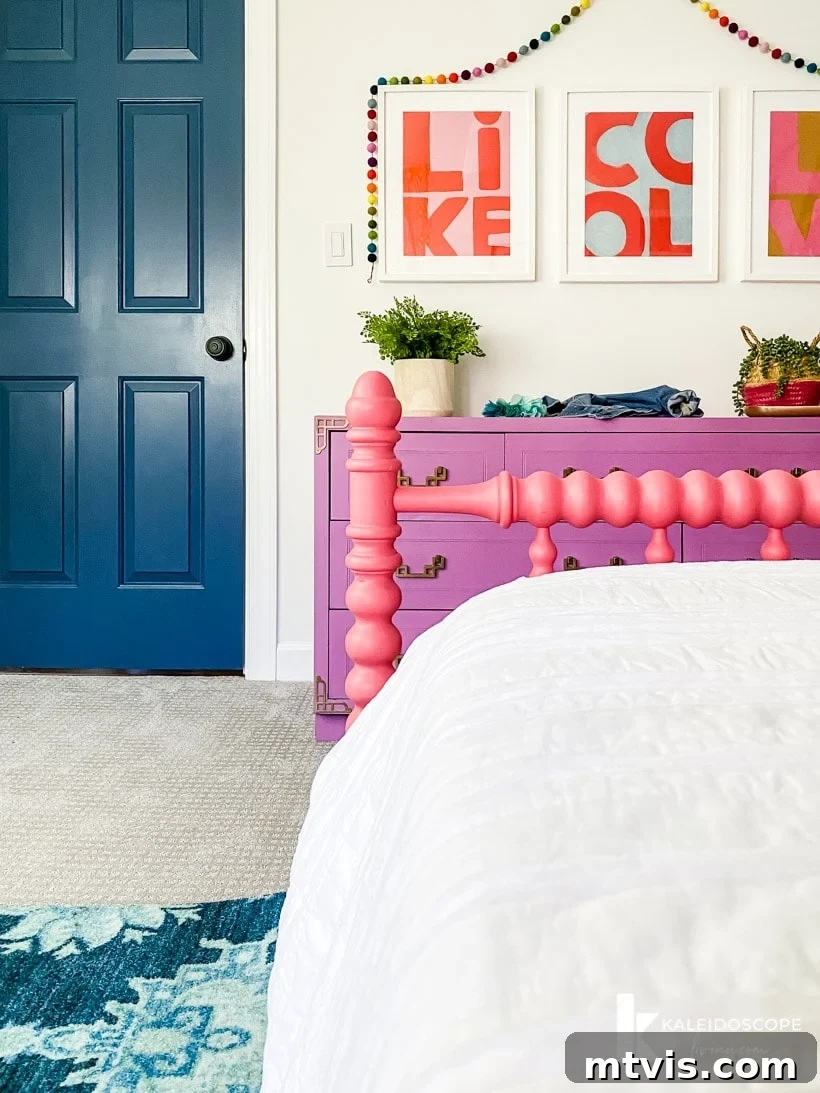 A bright and airy view of Attley's colorful girl's bedroom, featuring the full-size Jenny Lind bed, vibrant mural, and cohesive decor, perfect for inspiring girls' room designs.
