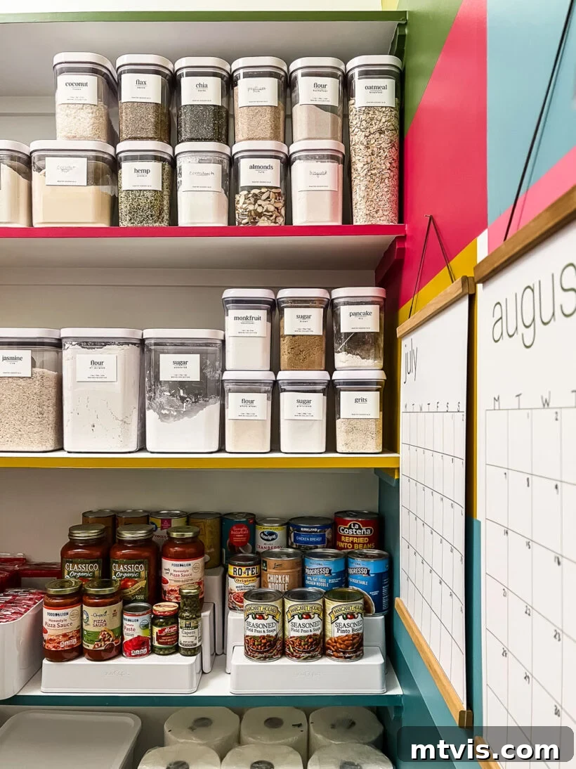 Smart Stylish Pantry Secrets 3 organized canned goods and decanted dry goods in colorful pantry makeover