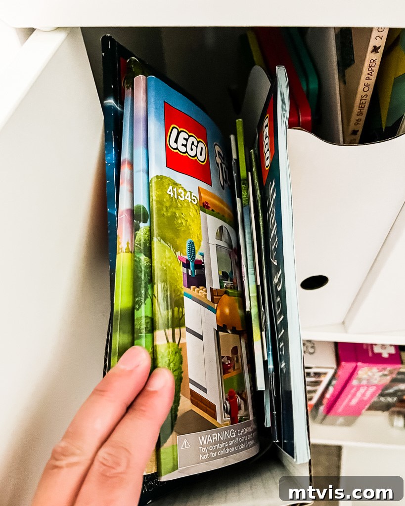 Transform Your Playroom: Simple Storage for a Clutter-Free Zone 4 An open cabinet revealing organized playroom storage ideas with magazine files for documents and crafts, highlighting functional solutions.