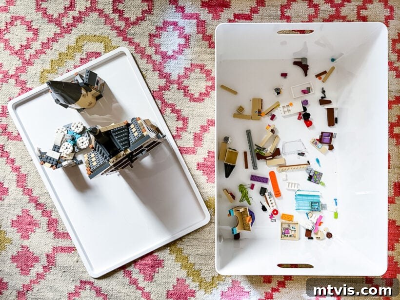 Transform Your Playroom: Simple Storage for a Clutter-Free Zone 10 A Lego creation assembled on the lid of a storage bin, illustrating how the lids double as portable building surfaces for kids in the playroom.