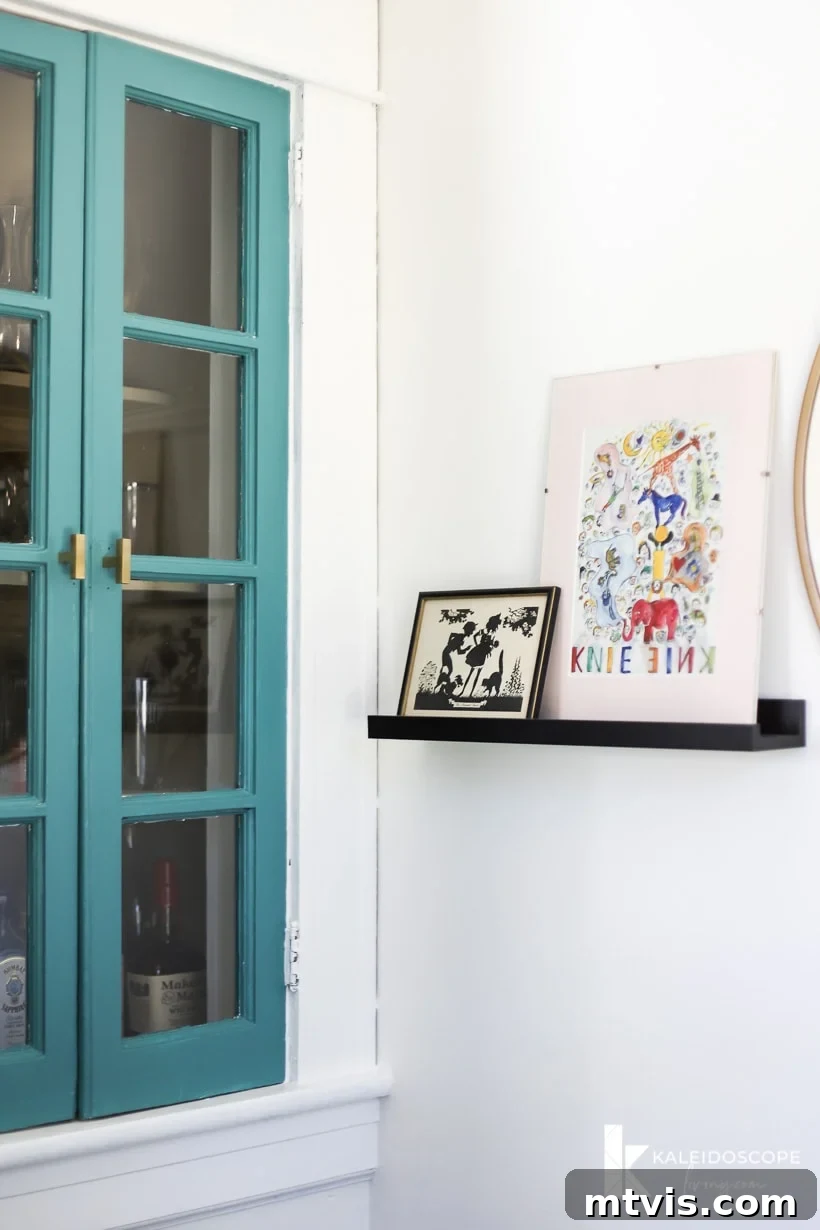 Thea Workspace Transformed 8 Colorful built-in cabinet and organized artwork in home office