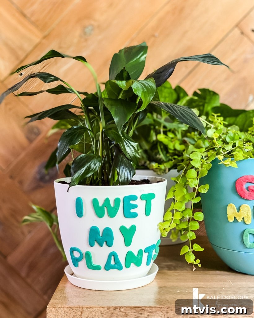 Beyond Basic Pots Polymer Clay Decorating with a Touch of Humor 12 A blue plant pot decorated with contrasting polymer clay letters spelling out a fun message.