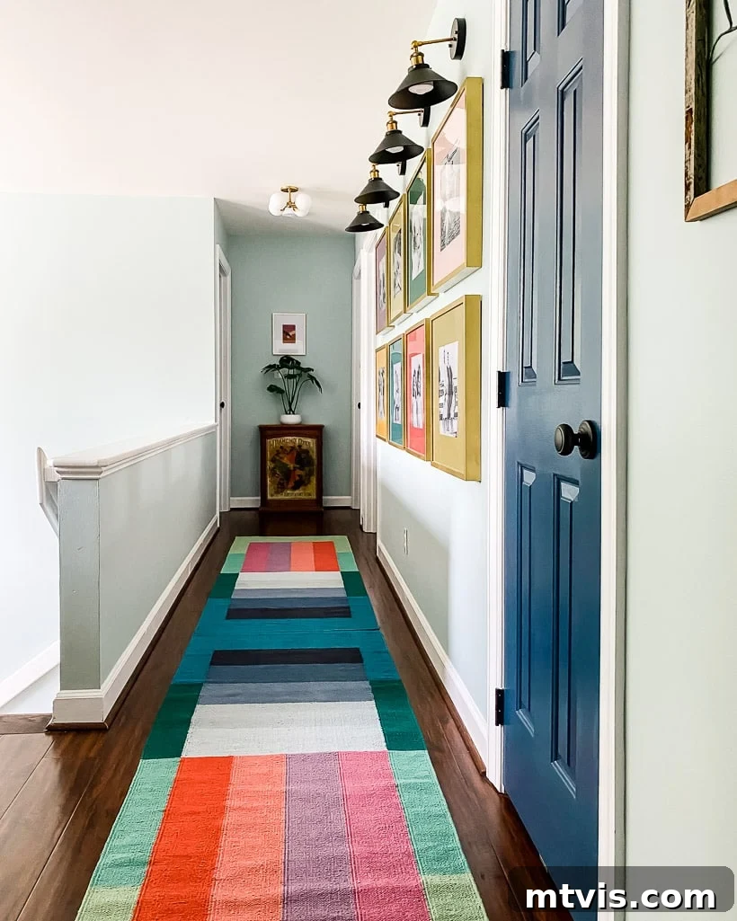 Close-up of a colorful runner in an upstairs hallway, complementing a DIY gallery wall.