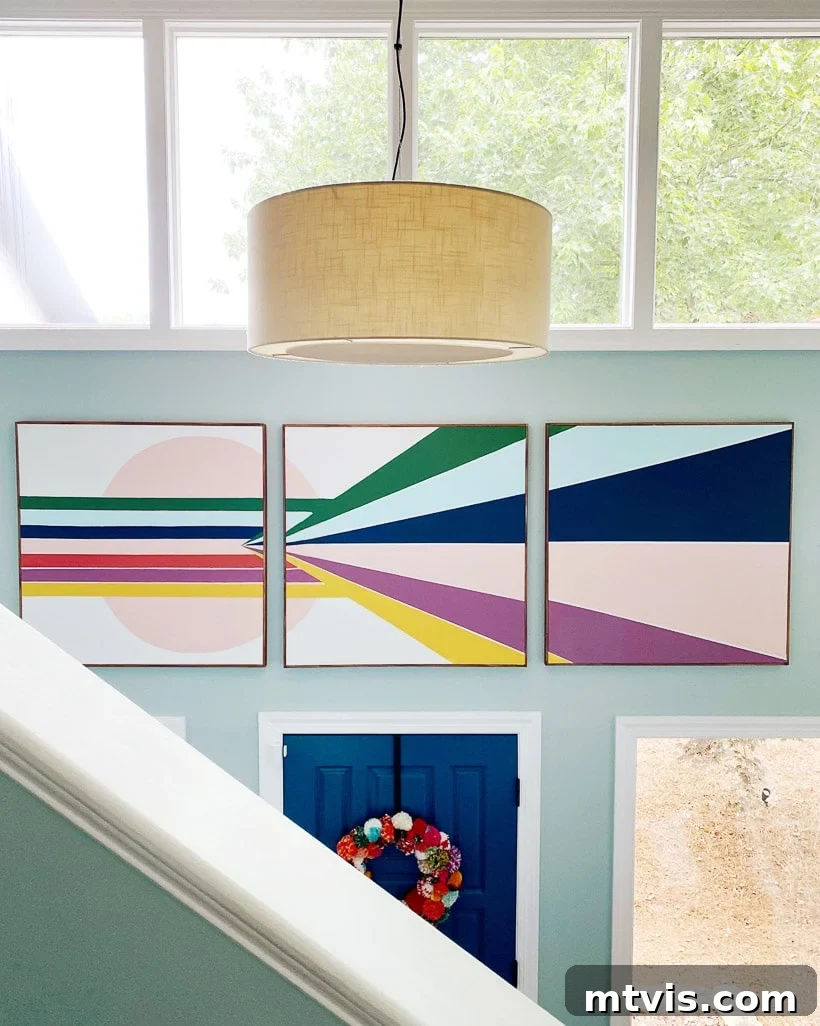 Large DIY mural canvases creating a dramatic focal point in a home foyer.