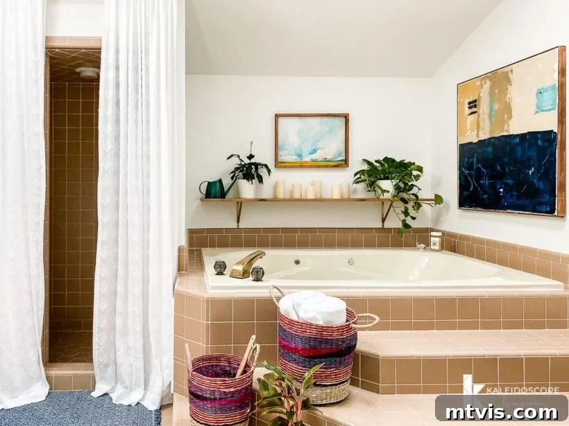Master Bathroom Remodel on a Budget The Big Reveal 14 master bathroom makeover with original tile - A view of the bathtub area, showing how plants and decor integrate with the existing brown tile.