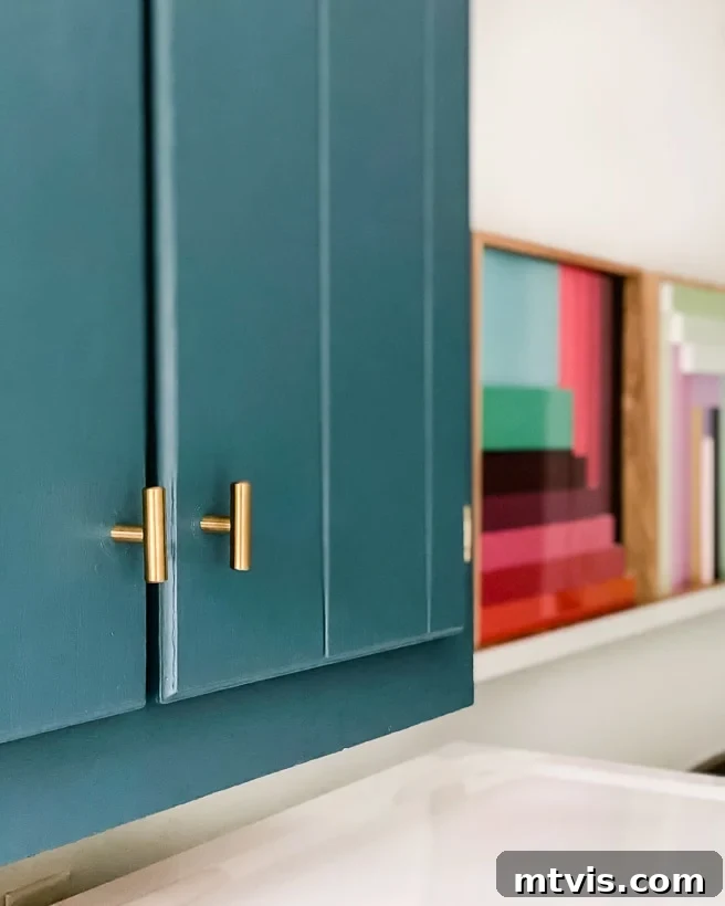 The Vibrant Laundry Room Transformation 6 teal painted cabinets with brass hardware