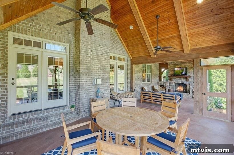 Inviting outdoor space featuring a comfortable eating area and a high vaulted ceiling.