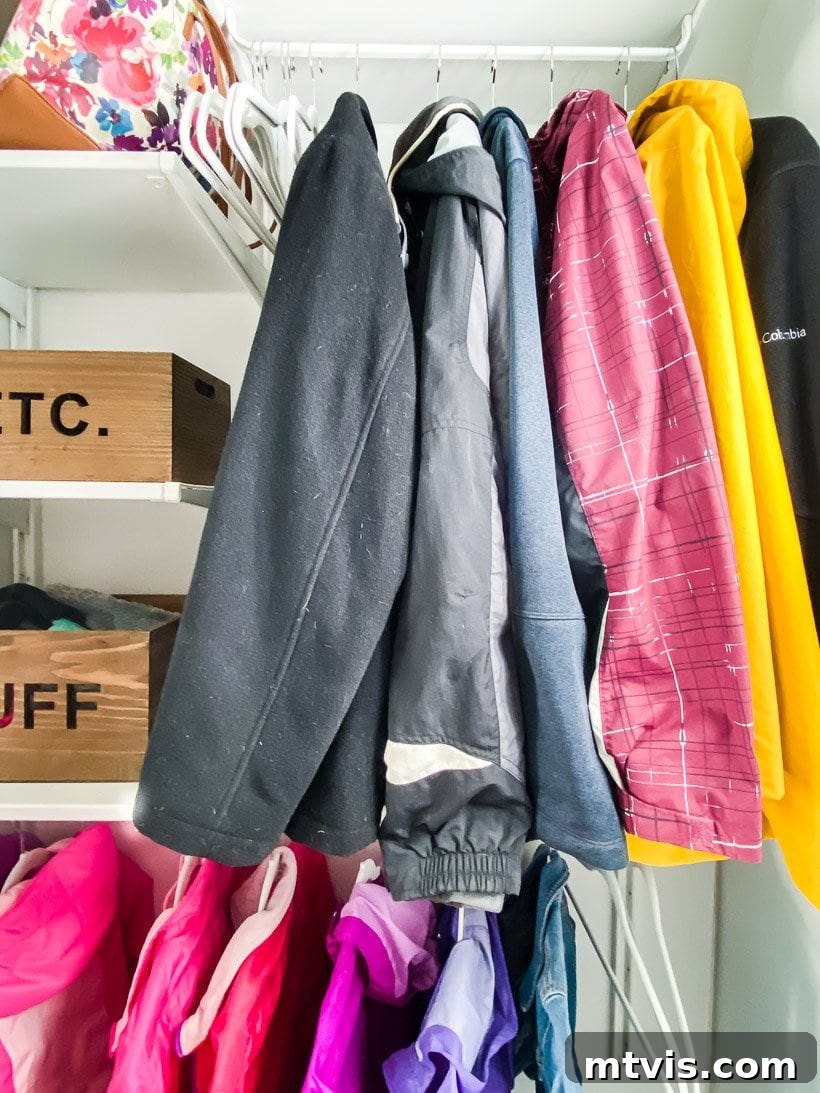 Declutter Your Coat Closet: The 100 Dollar Edition 4 organized coat closet interior with hanging rods and shelves