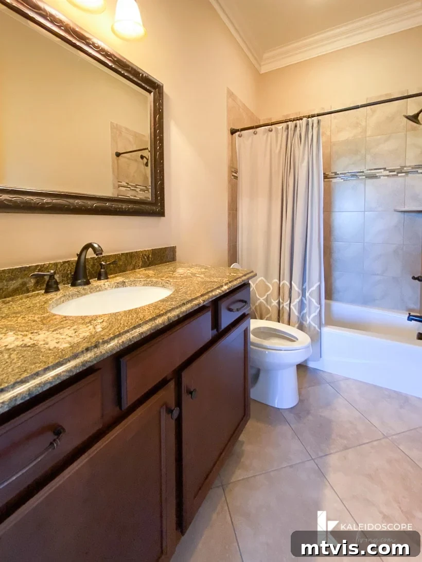 Our New House: The Blank Canvas Tour Part 1 17 Outdated guest bathroom featuring brown tile and a single vanity