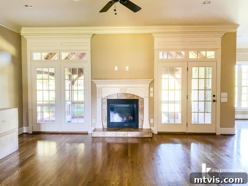 Our New House: The Blank Canvas Tour Part 1 7 Family room fireplace flanked by double doors, bright with natural light