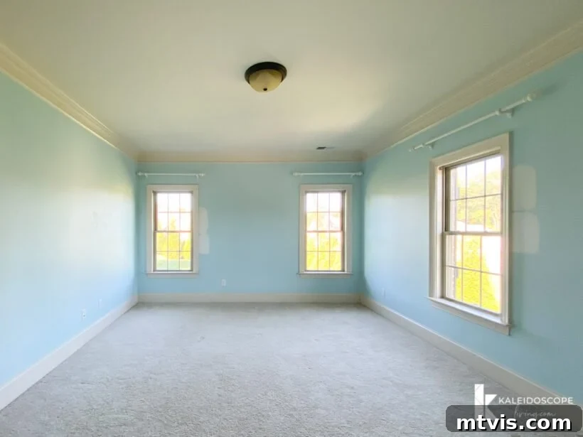 Unboxing Our New House: The Raw Tour Part 2 5 Attley's bedroom with blue walls and ample natural light, awaiting renovation.