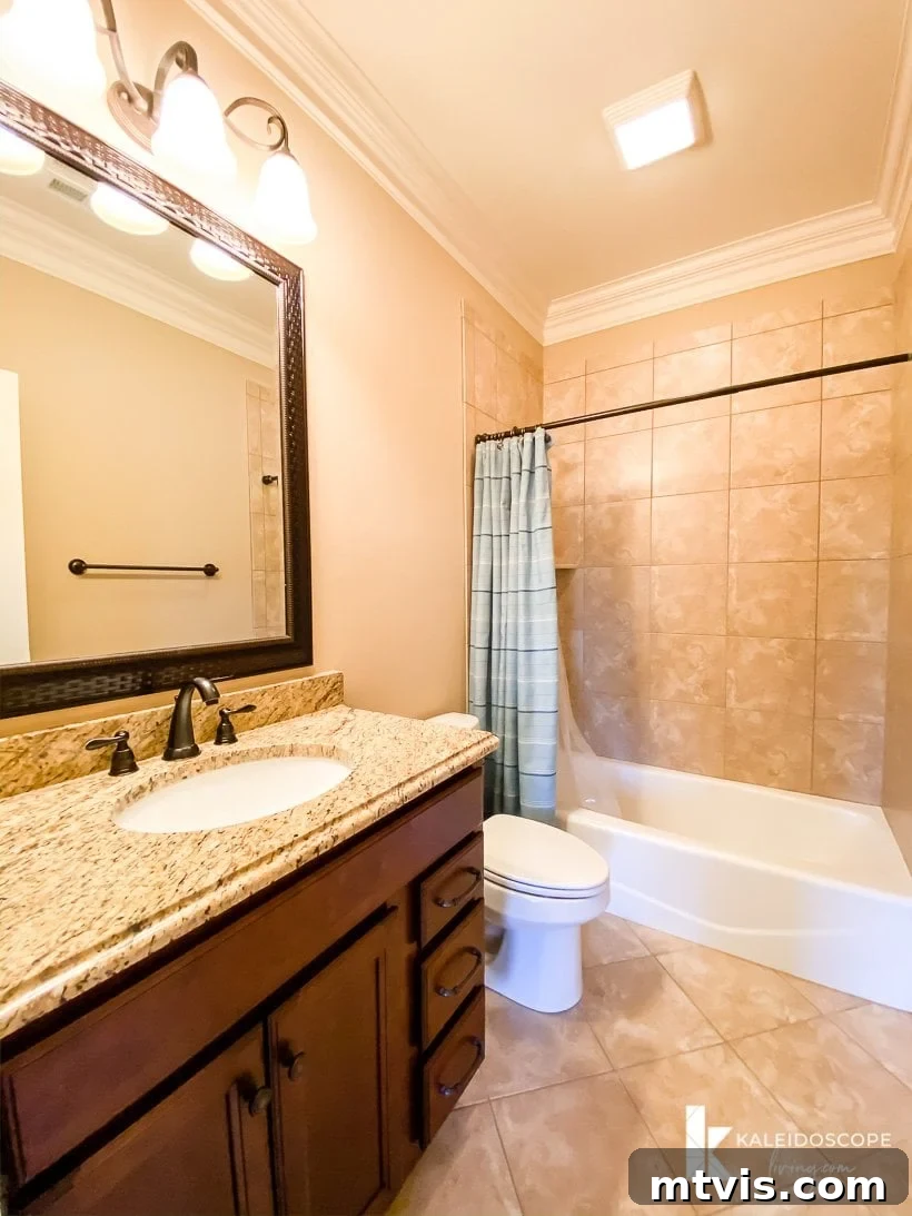 Unboxing Our New House: The Raw Tour Part 2 8 Avery's private bathroom, featuring extensive brown tiling and cabinetry.