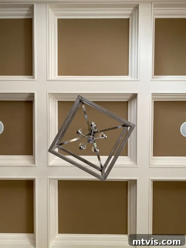 Step Inside Our Navy Blue Dining Room 4 Before the navy-blue dining room, the traditional beige and cream-colored coffered ceiling featured a conventional square light fixture, awaiting a contemporary update.