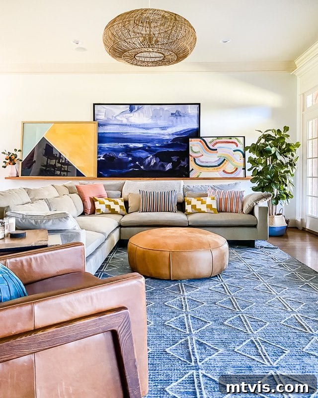 Transform Your Space: The Ultimate Guide to Large Wall Art 4 Large living room with a spacious sectional sofa and a prominent, colorful art display on a picture ledge, showcasing excellent scale.