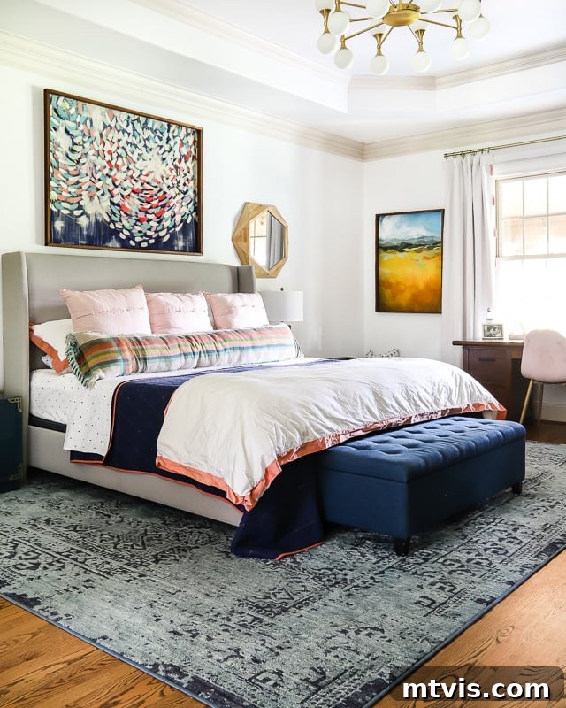 Transform Your Space: The Ultimate Guide to Large Wall Art 5 A colorful bedroom featuring a large piece of art above the bed and navy bedding, demonstrating effective use of scale.