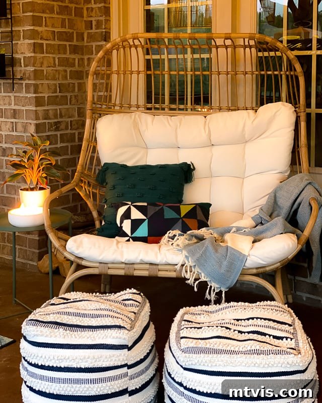 Outdoor Oasis: Screened Porch Tour & Decor Tips 12 Cozy screened-in porch with an egg chair, illuminated by soft lighting at night.