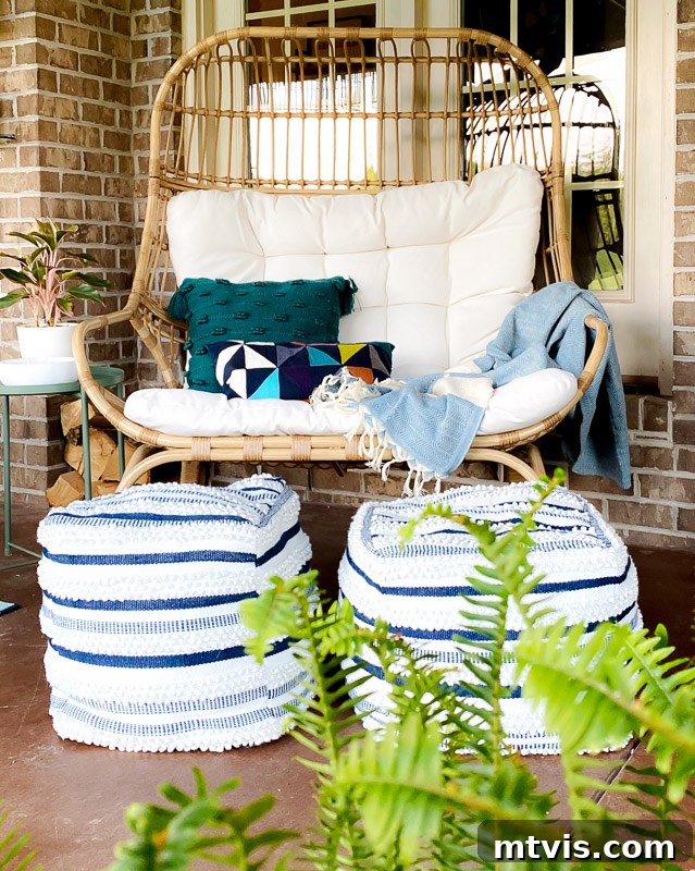 Outdoor Oasis: Screened Porch Tour & Decor Tips 7 Stylish Studio McGee egg chair set on a vibrantly decorated covered patio, showcasing pops of color.