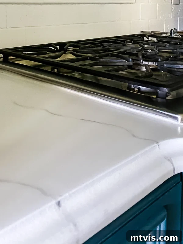 Paint Your Countertops Like a Pro: Essential Tips for a Flawless Finish 23 marble painted kitchen countertops after caulking by Tasha Agruso of Kaleidoscope Living