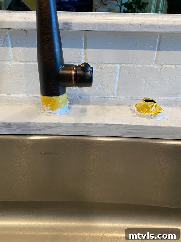 Paint Your Countertops Like a Pro: Essential Tips for a Flawless Finish 7 taped off kitchen faucet for painting counters by Tasha Agruso of Kaleidoscope Living