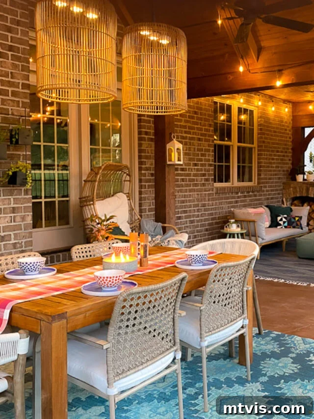 Build Your Own Outdoor Chandelier 13 Beautiful screened-in porch featuring the DIY outdoor chandelier hanging over a dining table with vibrant colorful accents and a teal blue rug.