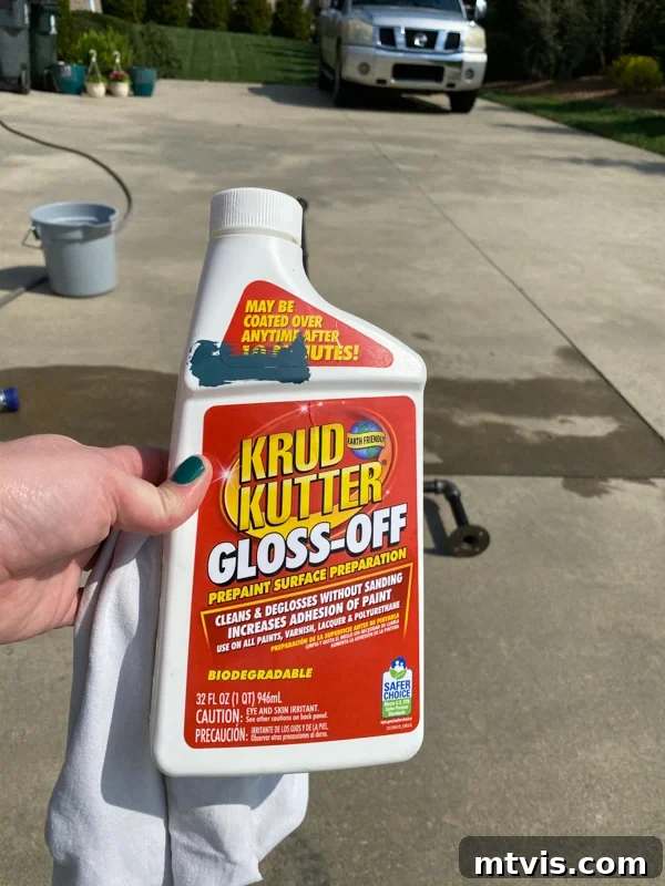 Build Your Own Outdoor Chandelier 3 Woman cleaning gas pipe with Krud Kutter gloss-off cleaner to prepare for DIY outdoor chandelier assembly.