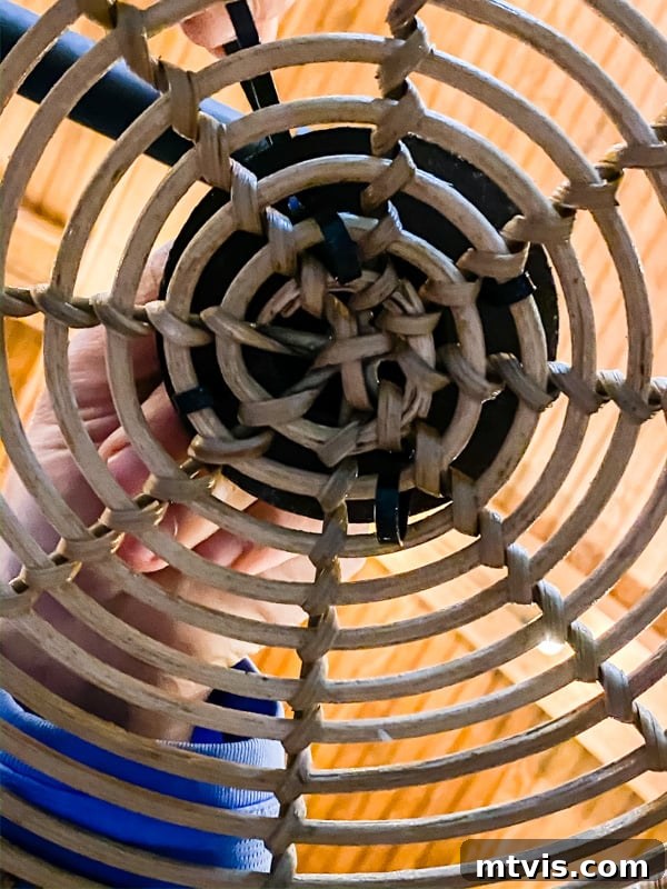 Build Your Own Outdoor Chandelier 10 Another view of zip ties securing a basket to a floor flange, demonstrating the attachment method for the DIY outdoor chandelier.