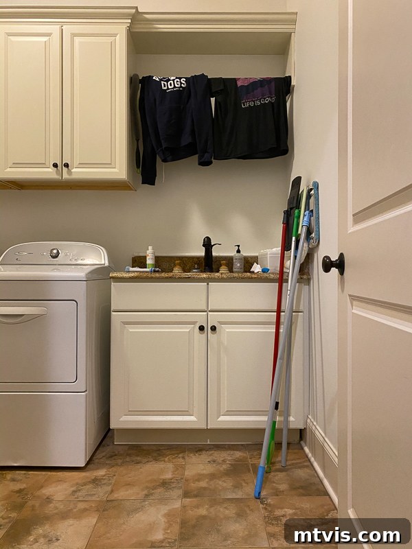 Unveiling Our Chic Modern Laundry Oasis 4 outdated laundry room before makeover - cabinets