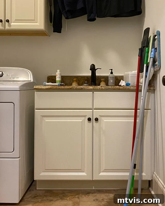 Unveiling Our Chic Modern Laundry Oasis 9 outdated sink cabinet and countertop before makeover