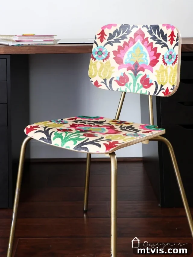 Upcycle Furniture with Fabric Decoupage 2 Close-up of a chair back decoupaged with colorful fabric, showcasing the unique pattern and texture