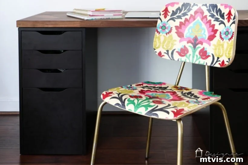 Upcycle Furniture with Fabric Decoupage 6 Decoupaged wood chair with fabric in front of a modern desk, showcasing a vibrant pattern