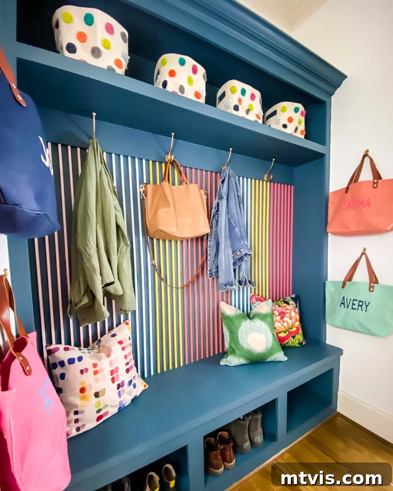 Modern Wood Slat Wall Transformation 11 After: A vibrant and functional mudroom featuring a new wood slat accent wall, bursting with color and style