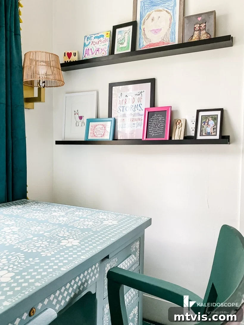 Colorful art on photo ledges in an office makeover, showcasing layering