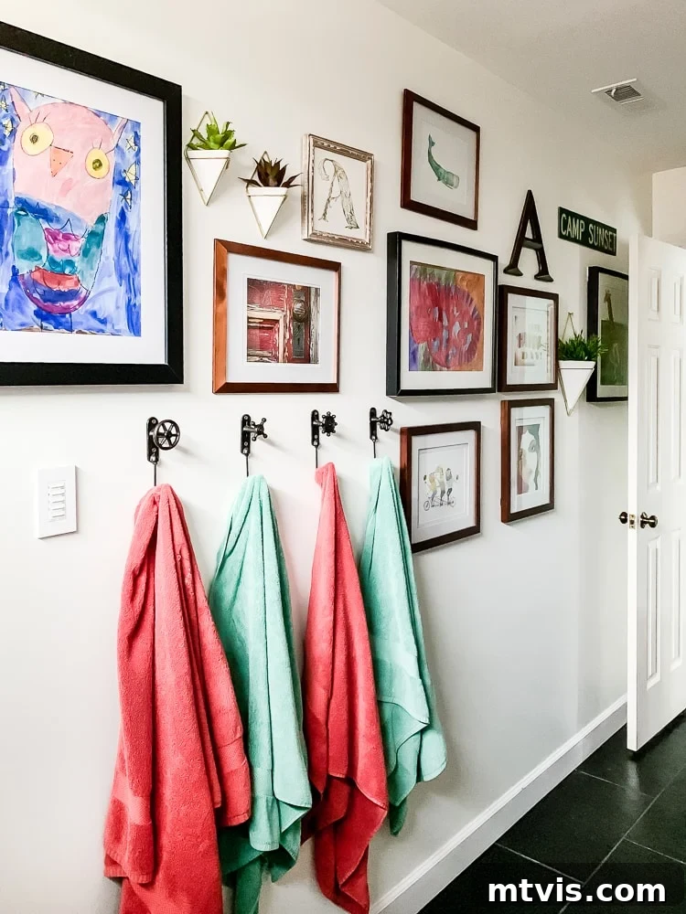 Colorful gallery wall in a bathroom, featuring mixed small and medium art