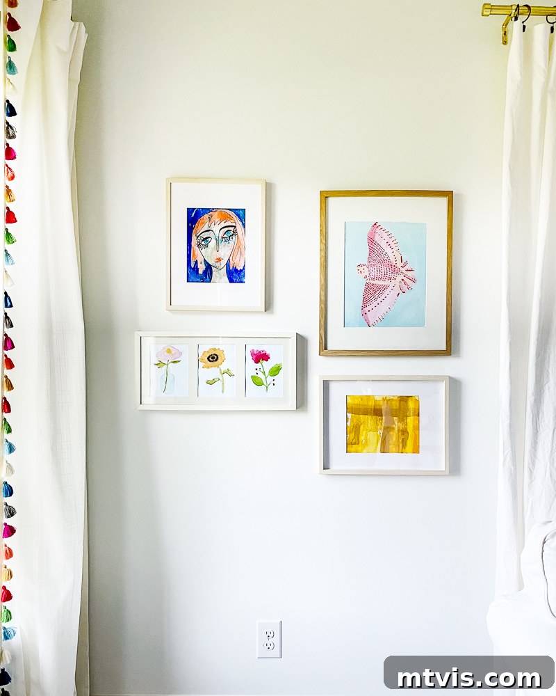 Seamless Spaces: Discover Our Gallery of Flowing Colors 19 Vibrant gallery wall in a girl's room, featuring a pink owl print, abstract art, and personal drawings.